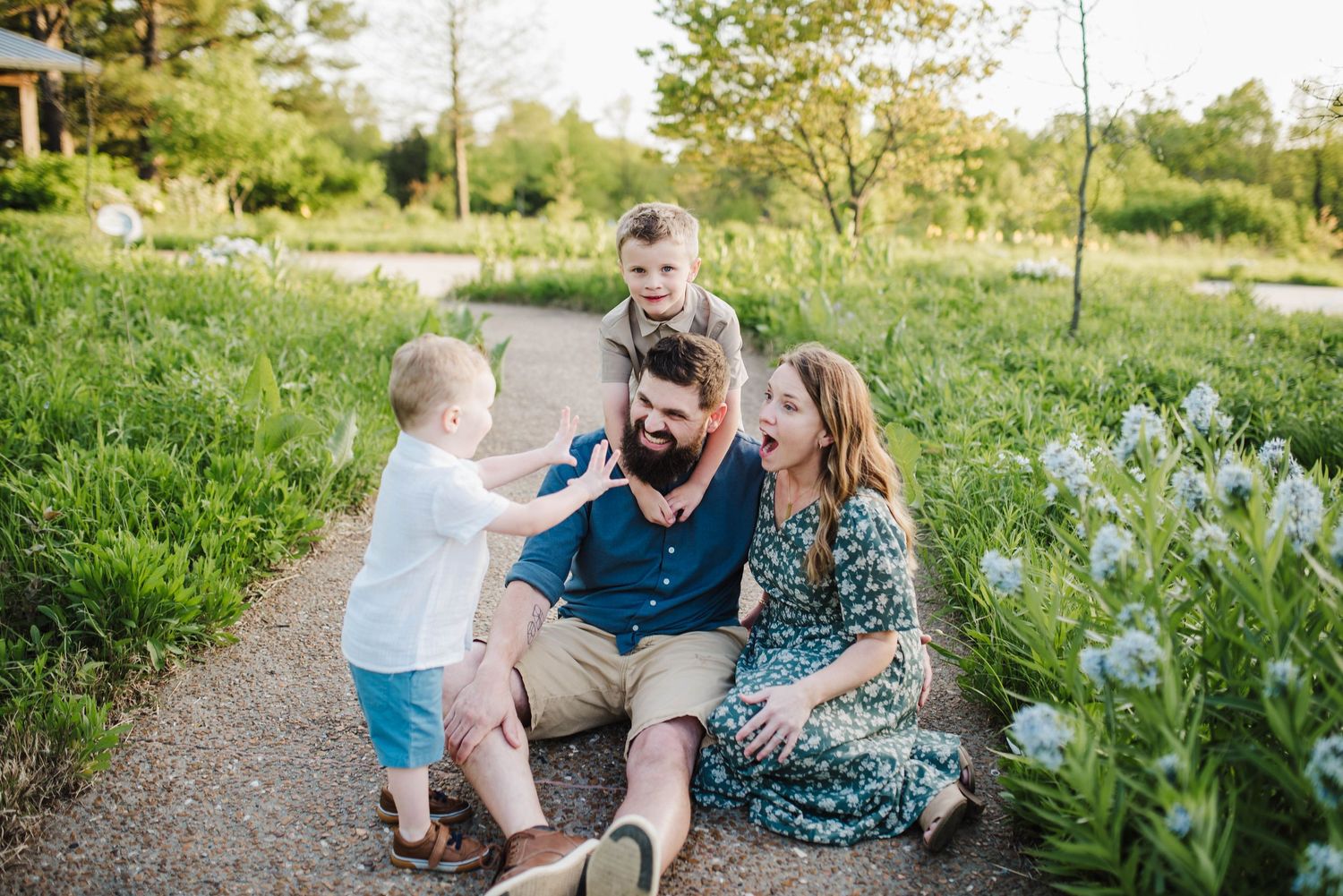 Family enjoys quality time together in a blooming garden setting.