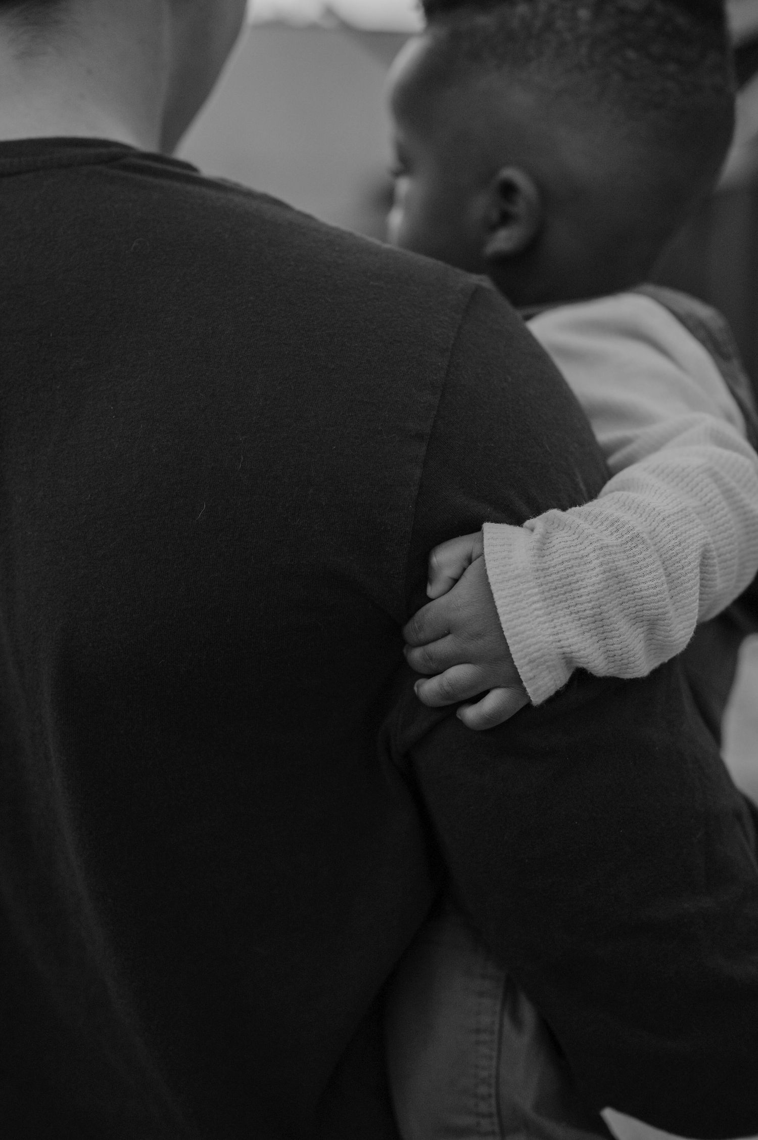 Close-up black and white shots of intimate family moments.