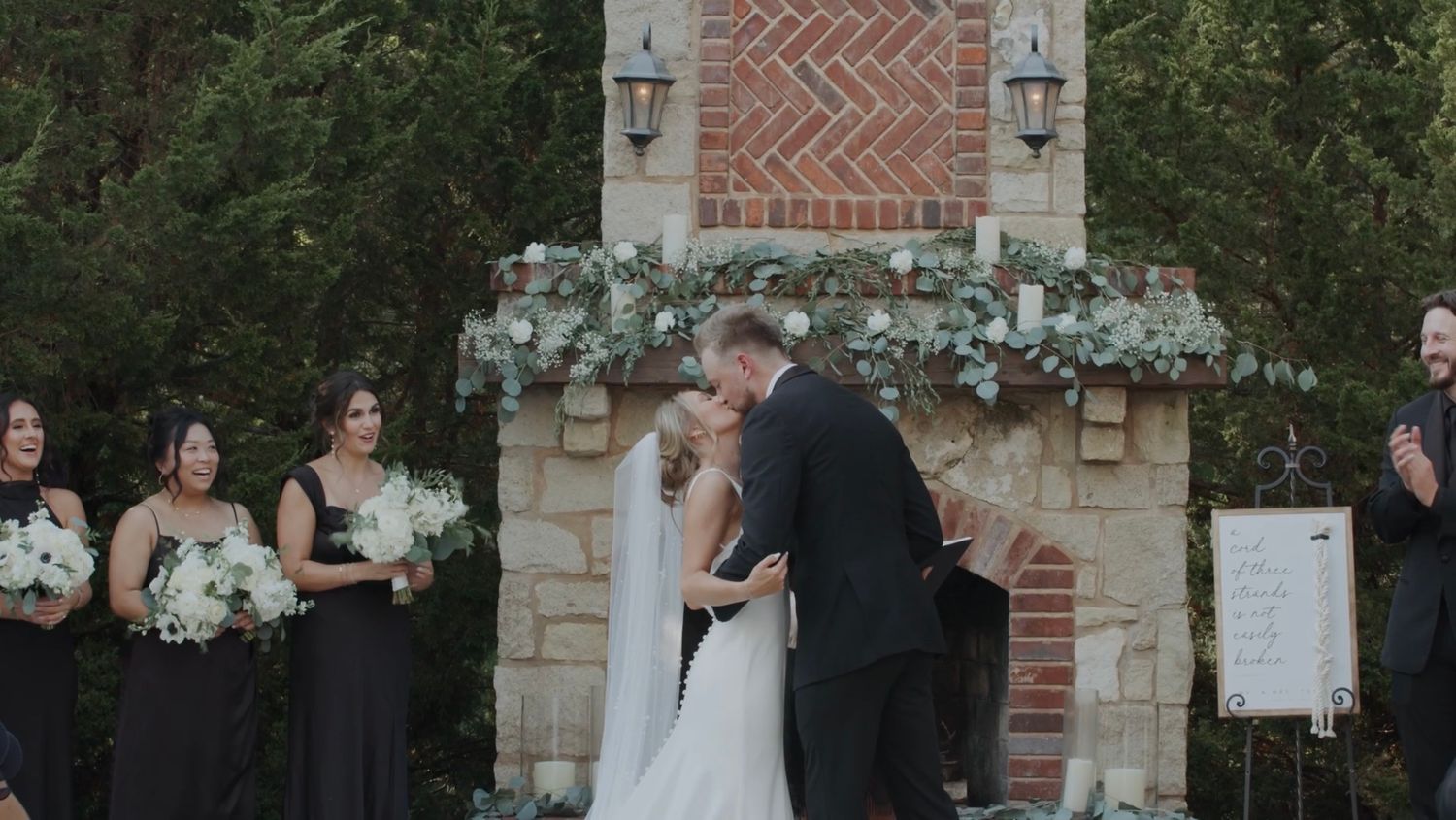 Wedding ceremony setup outdoors with brick and stone architectural details.
