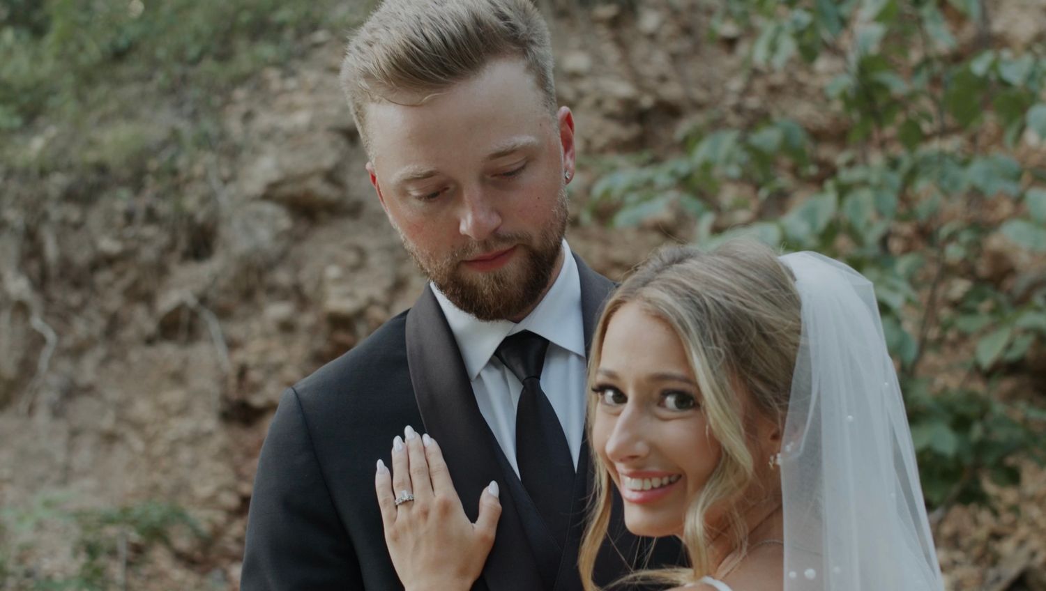 Romantic outdoor wedding photography session in a natural wooded setting.