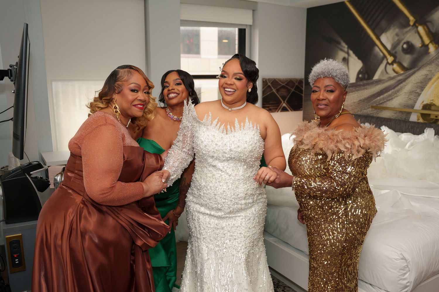 Wedding party wearing sparkly brown dresses and white gown celebrate together.