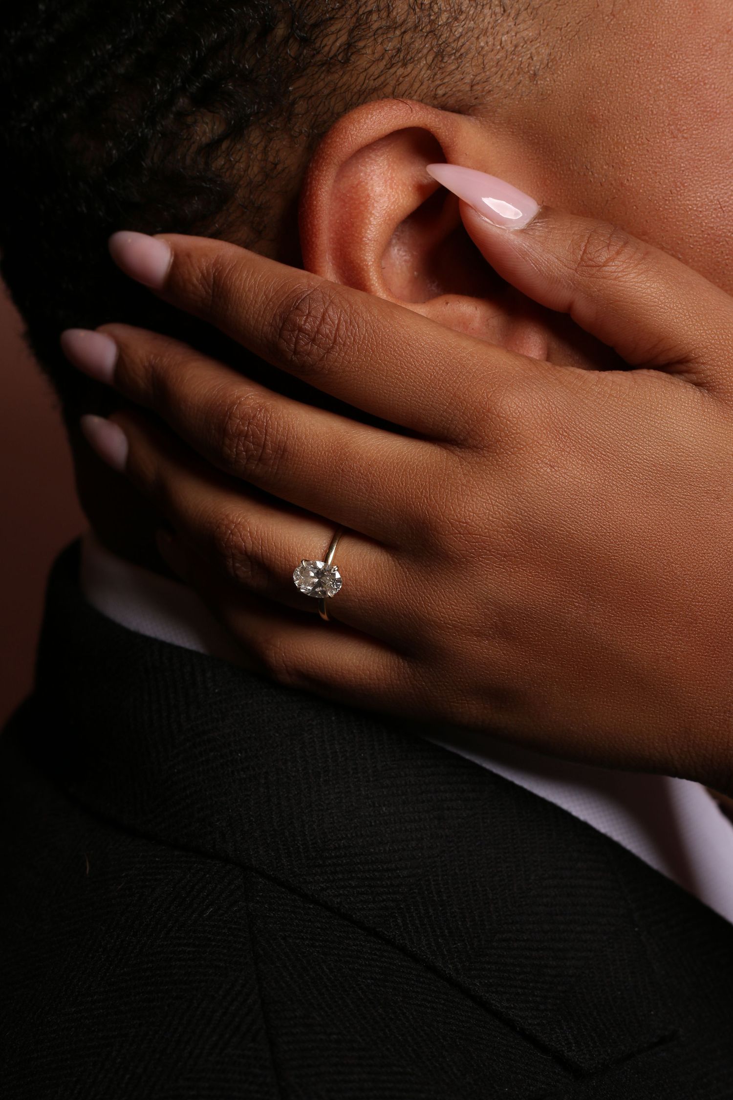 Close-up series showing an elegant diamond engagement ring on a hand against a dark background.