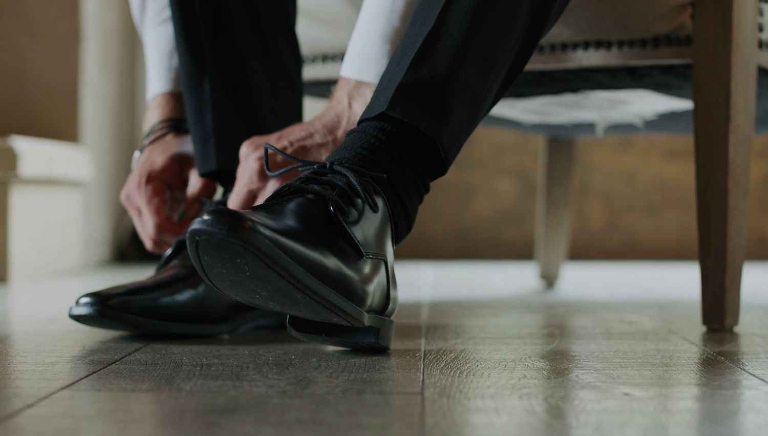 Close-up shot of formal black dress shoes being put on.