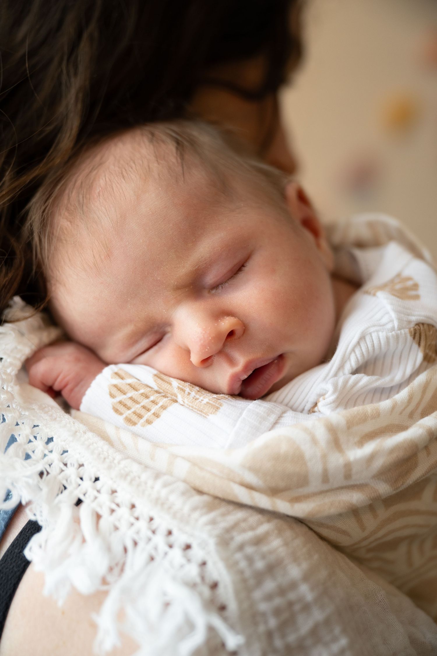 Sleeping newborn wrapped in delicate white lace blanket by WOnderland Photography - in-home newborn session.
