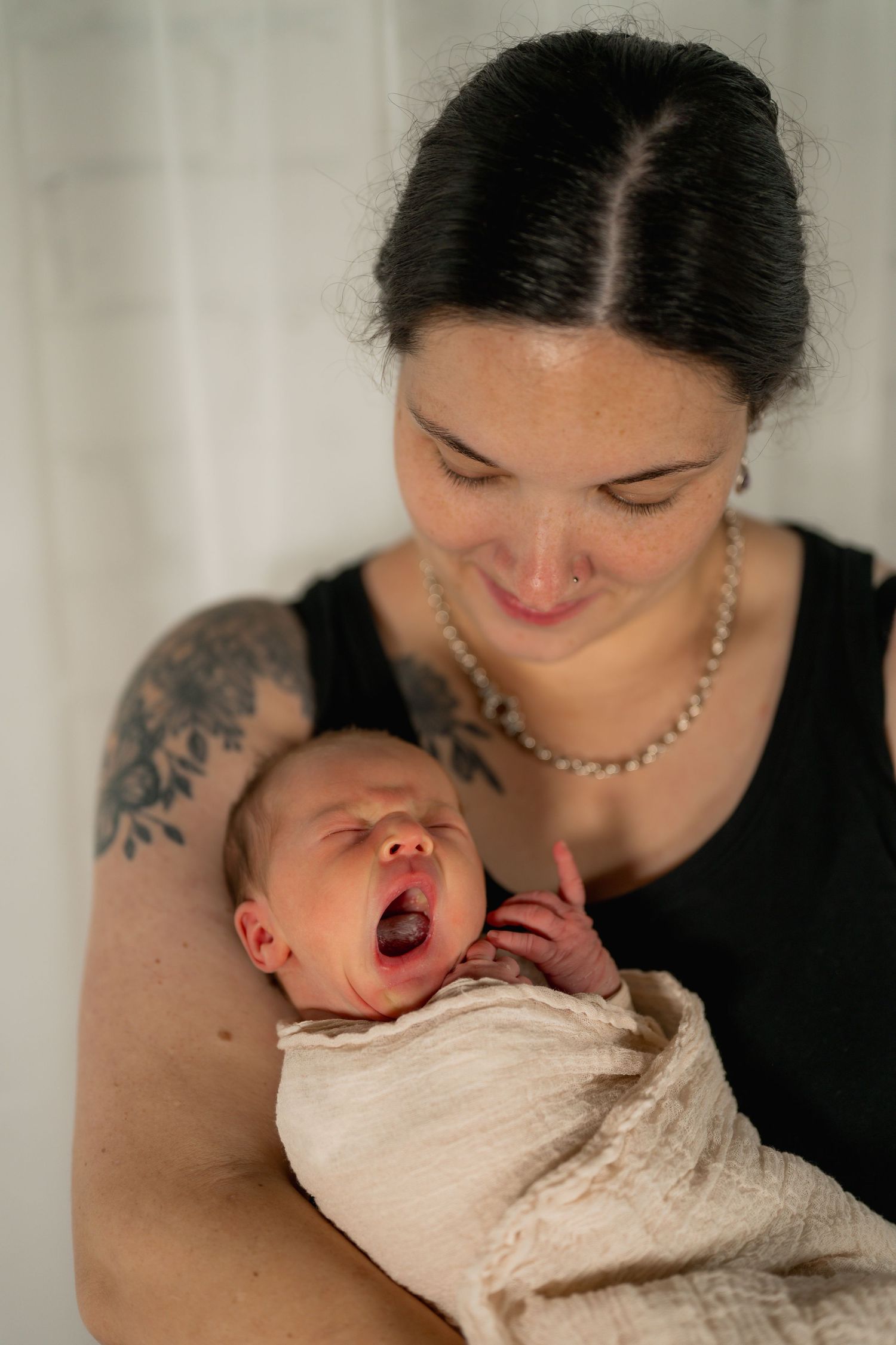 Mother cuddling newborn during studio newborn photography session in Tweed Heads