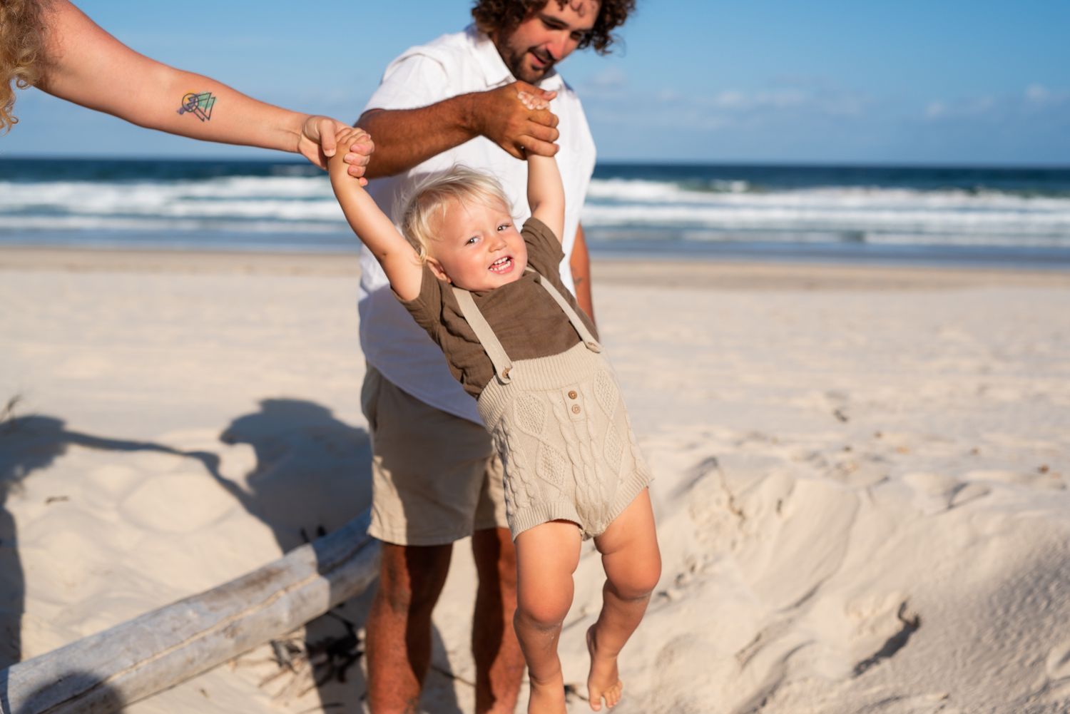 Family playing at Salt Beach, Kingscliff while on holidays