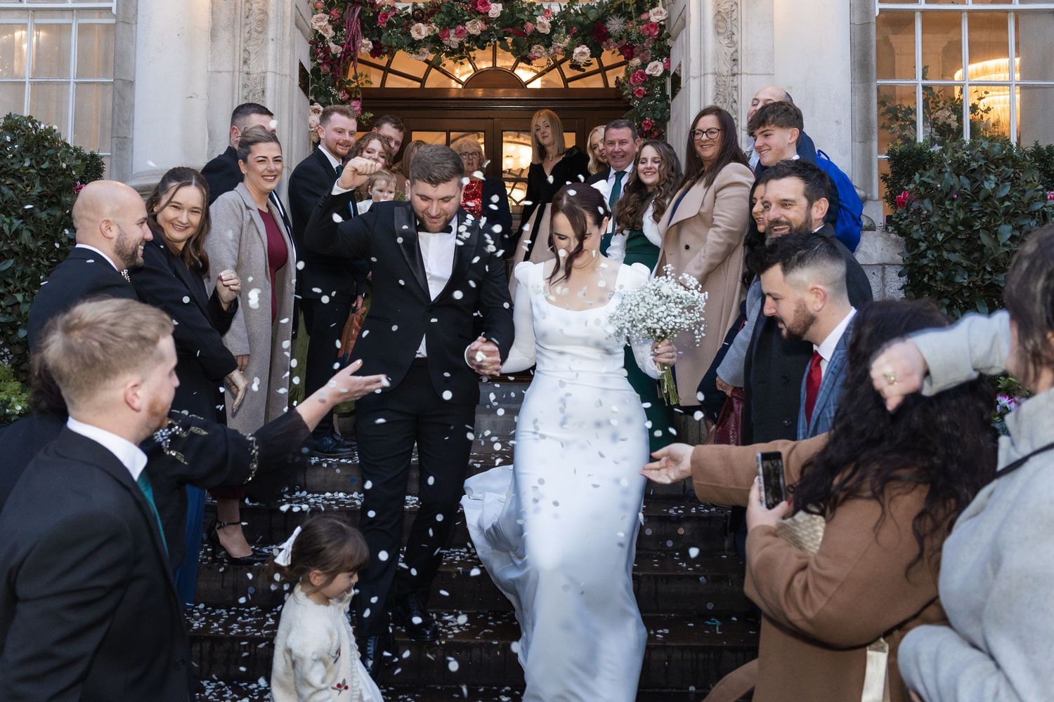 Guests throwing confetti as the couple stand in front of London Town hall.