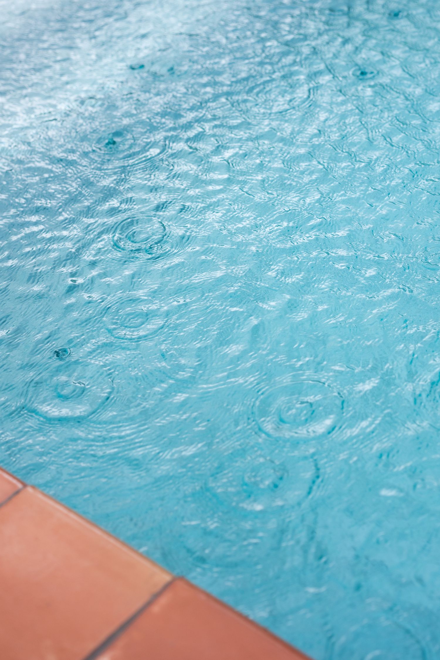 Terracotta pool side tiles with complementary teal pool water.