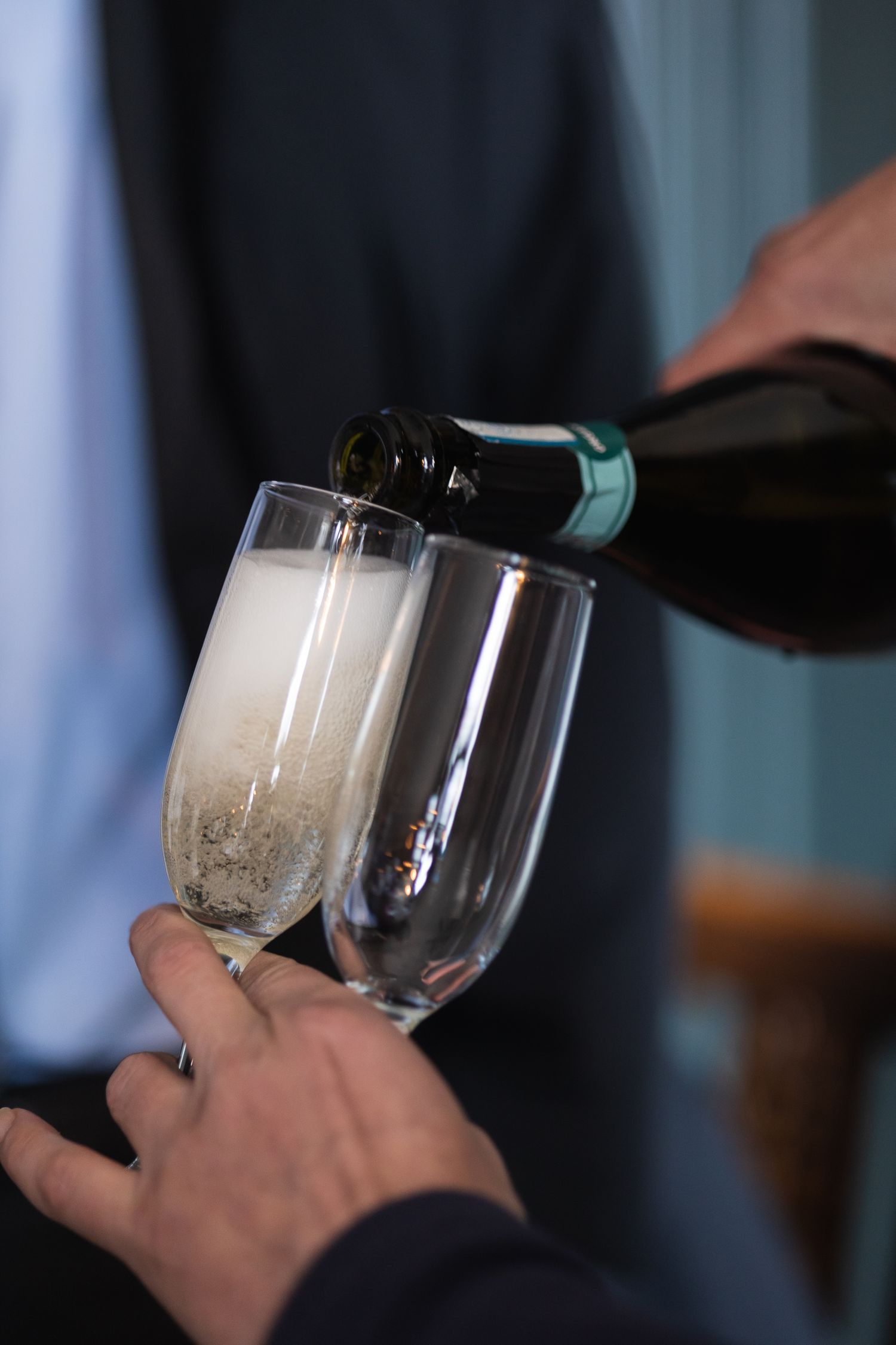 Glass of champagne being poured at wedding reception.