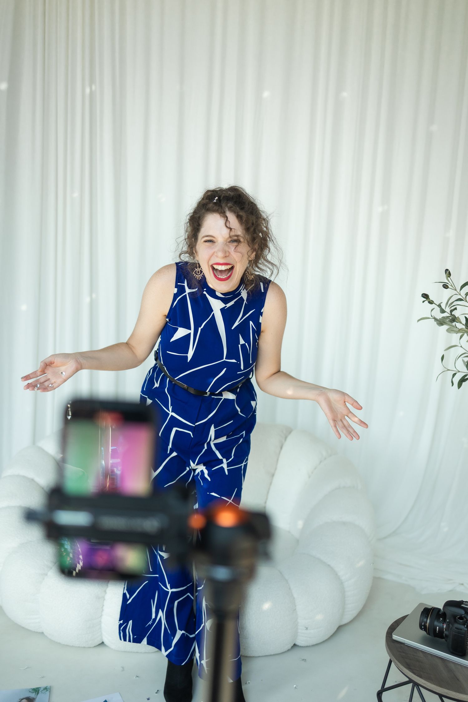 Behind the scenes on a branding shoot where we are also recording content using mobile phone on a tripod.