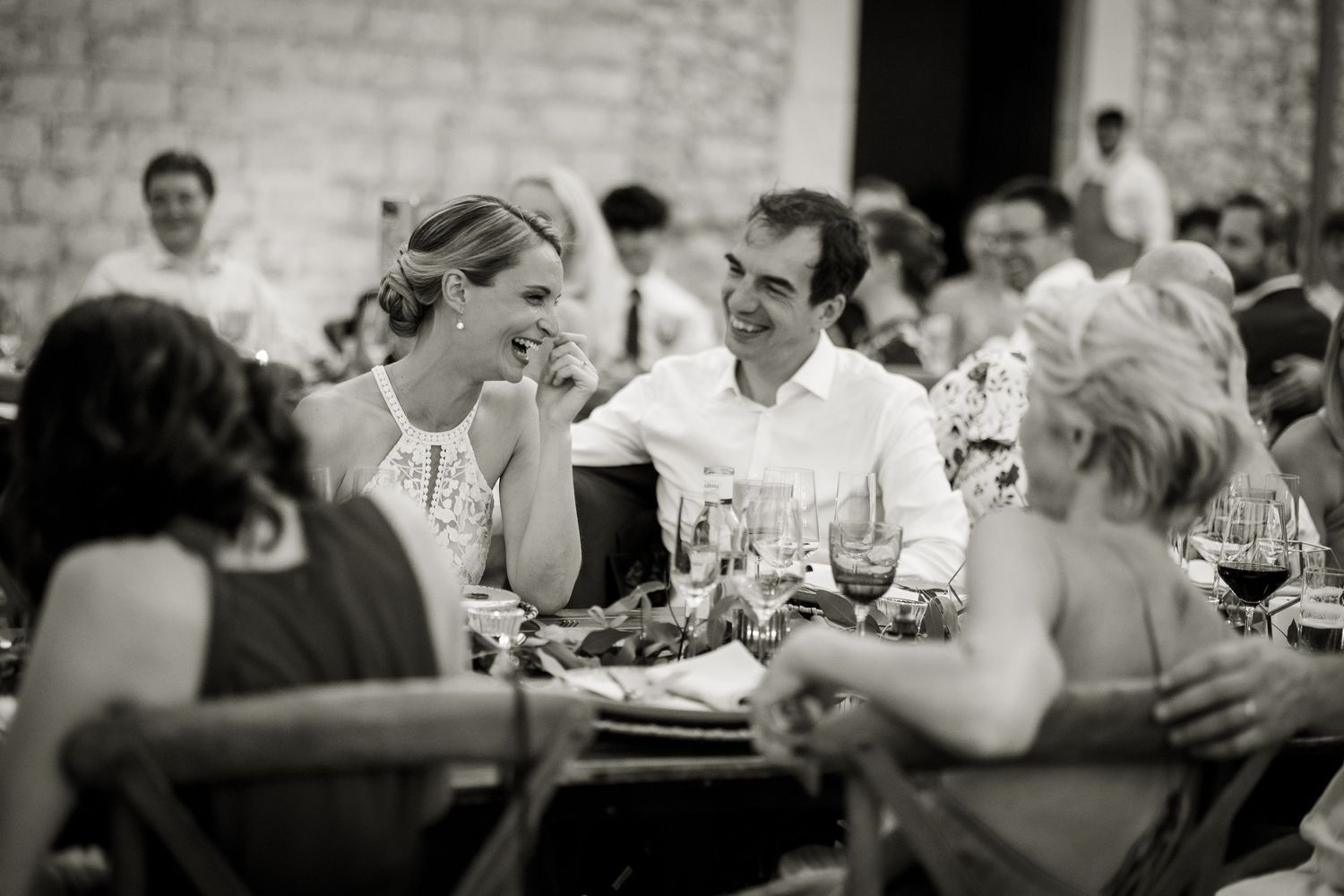 Genuine intimate moment between the bride and groom during the speeches of their wedding day. Nothing posed, just honest moments.