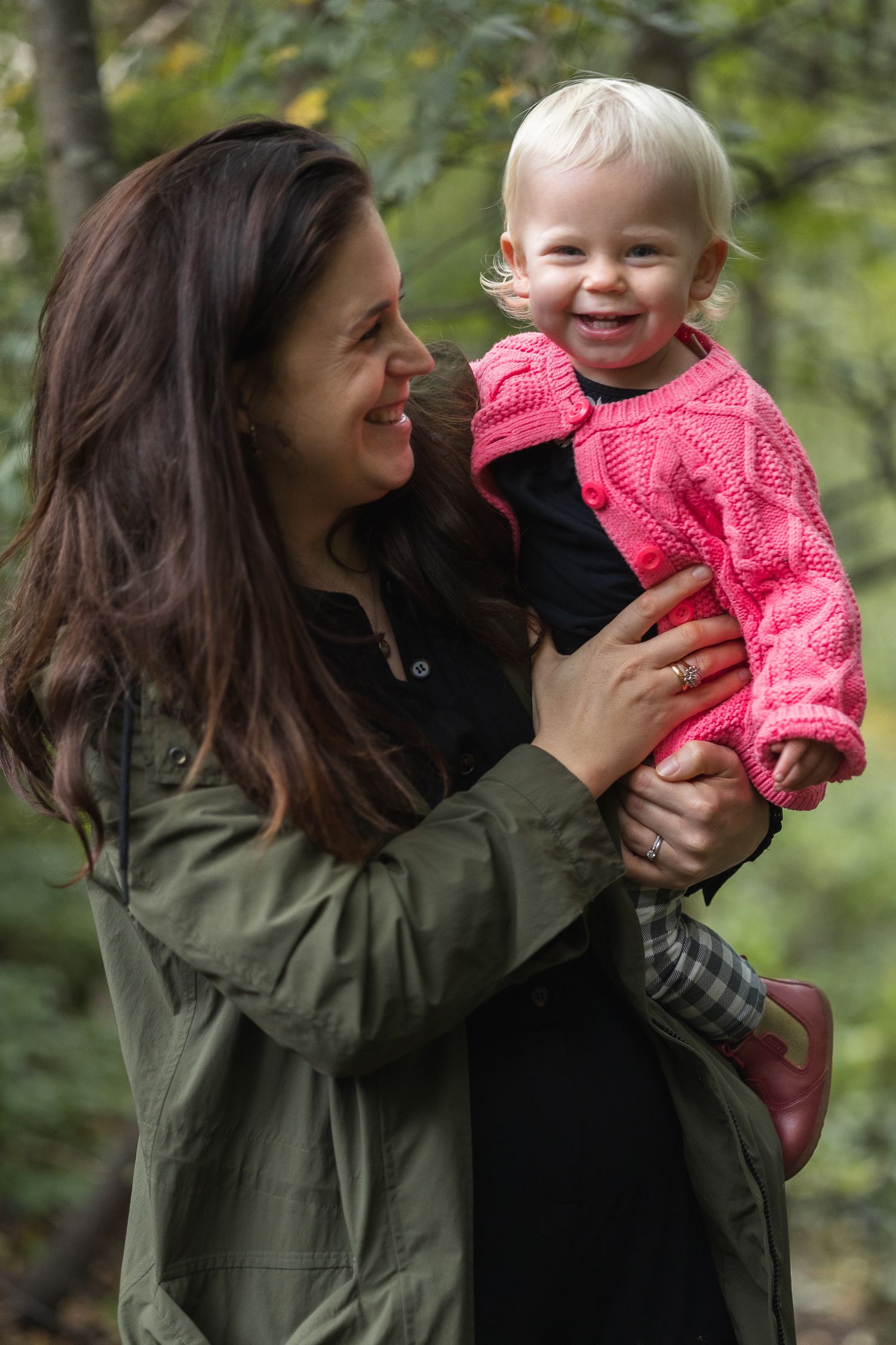 Relaxed image of mum joking around with her smiley toddler daughter.