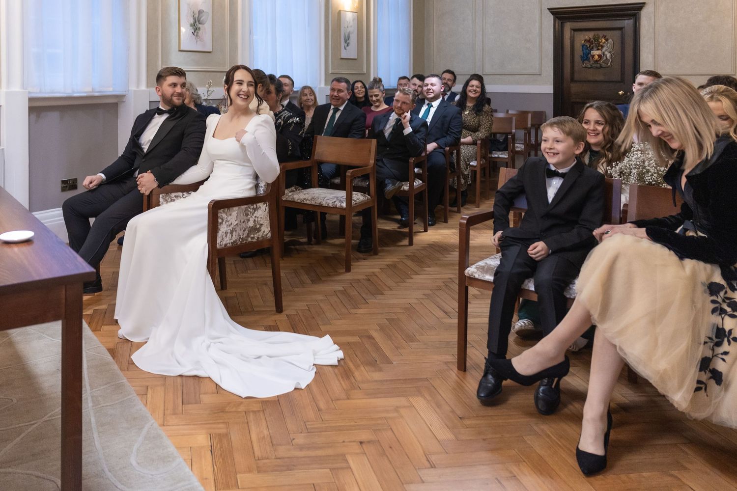 Lots of laughs between the guests during the wedding ceremony at London Town Hall wedding.