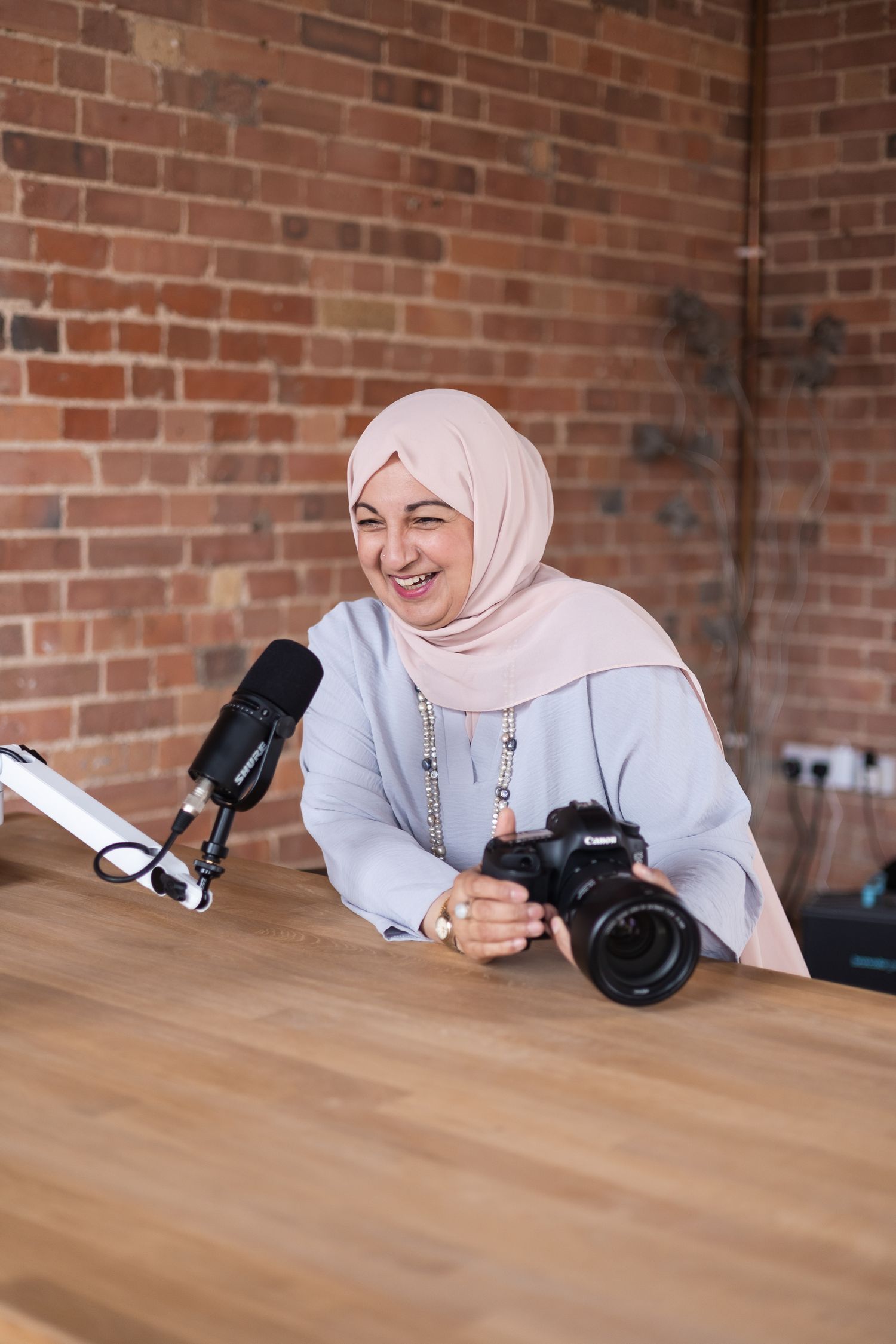 Behind the scenes moment captured of a business owner talking on a podcast in a studio in North London.