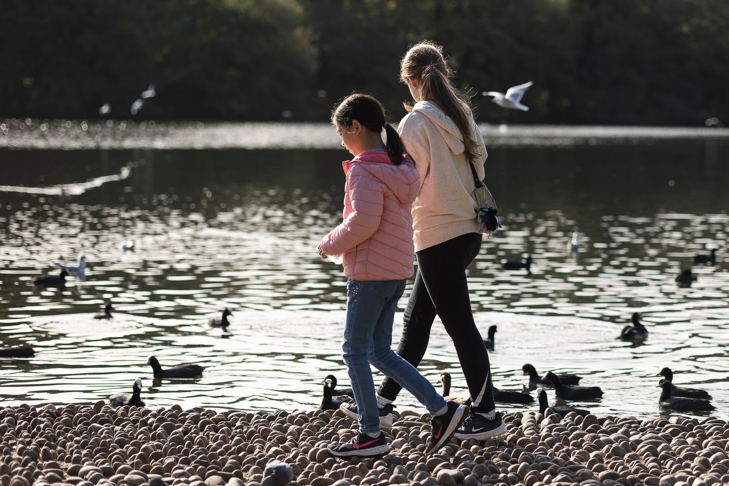 Cousins walking around Lake in Grovelands Park in Enfield