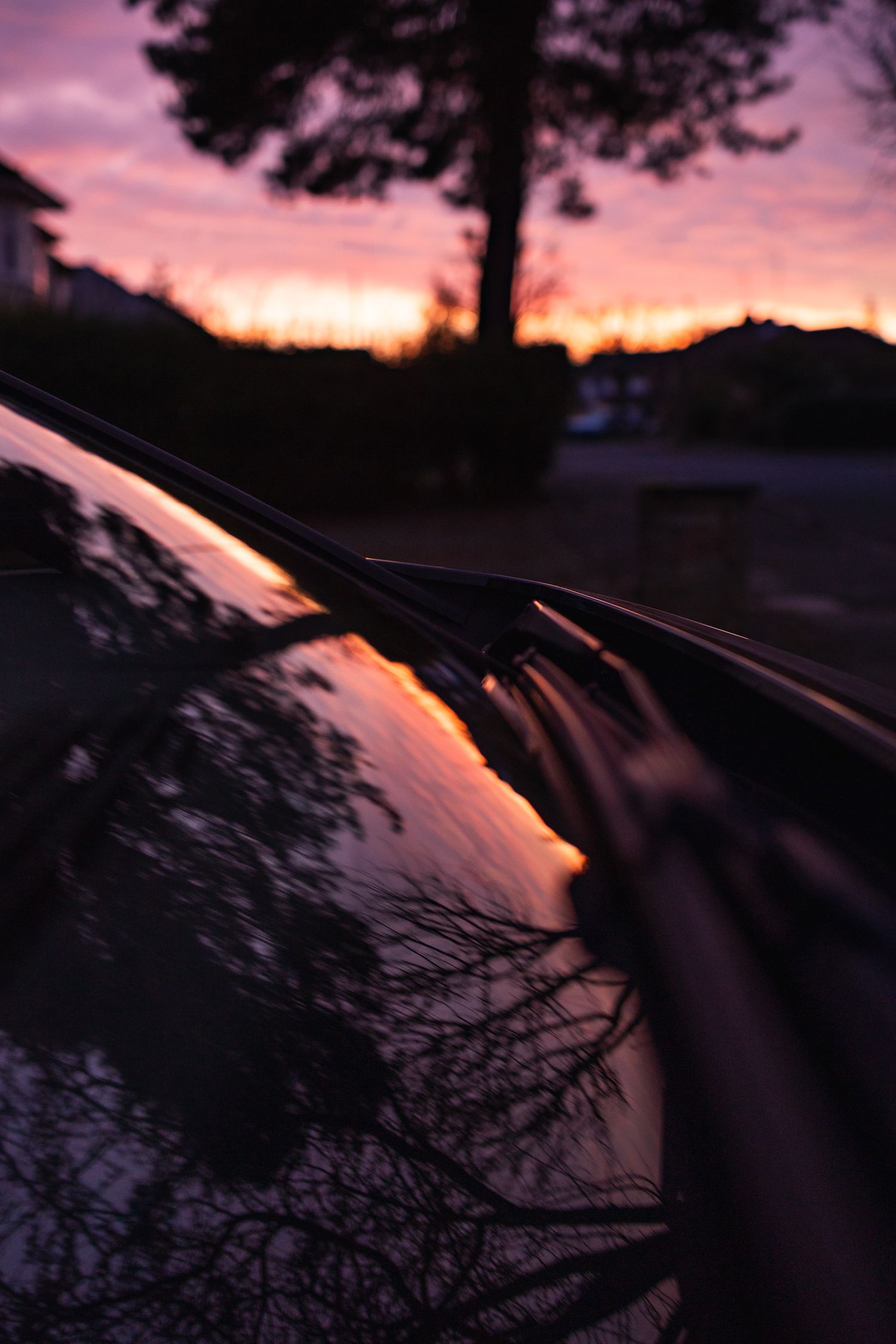 Beautiful pink and orange sunset captured, plus the reflection of this on the car windscreen.