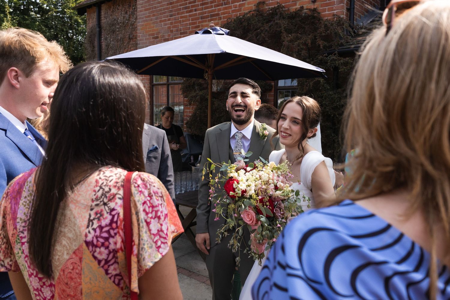 The bride and groom chatting to the guests at their reception.
