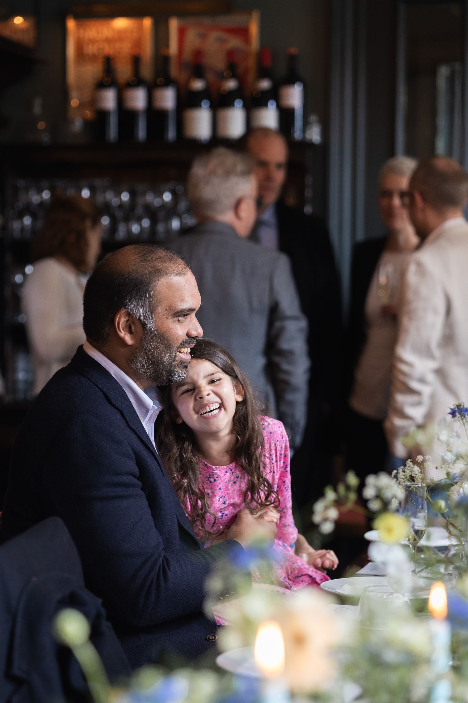 Relaxed girl and dad guests at reception party after Christening ceremony.