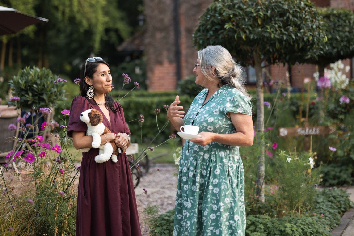Candid shots of guests chatting and enjoying themselves in the garden at an at-home wedding reception in Ware.