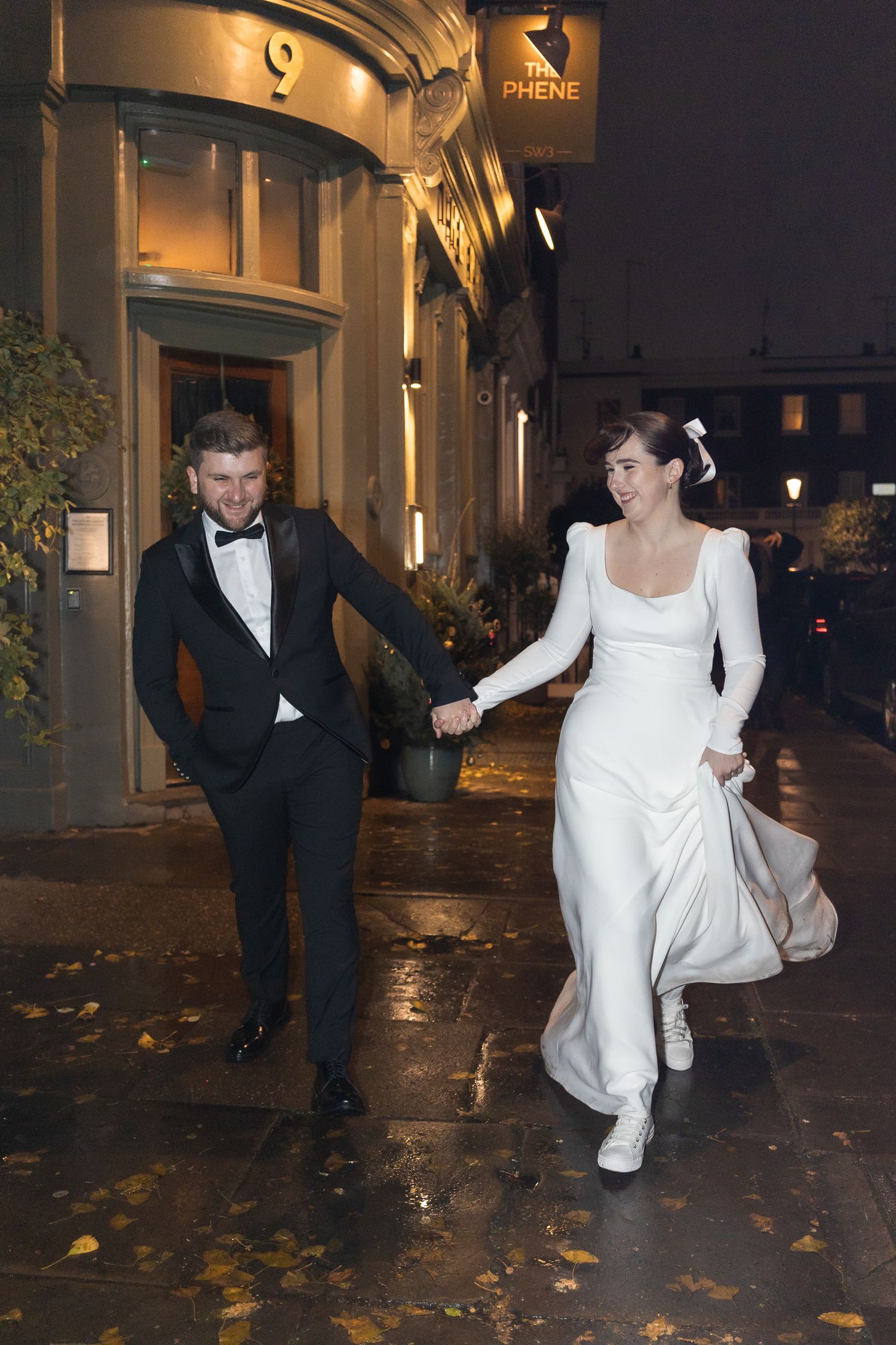 Natural and candid image taken with flash of couple outside the Phene, after their Chelsea wedding.