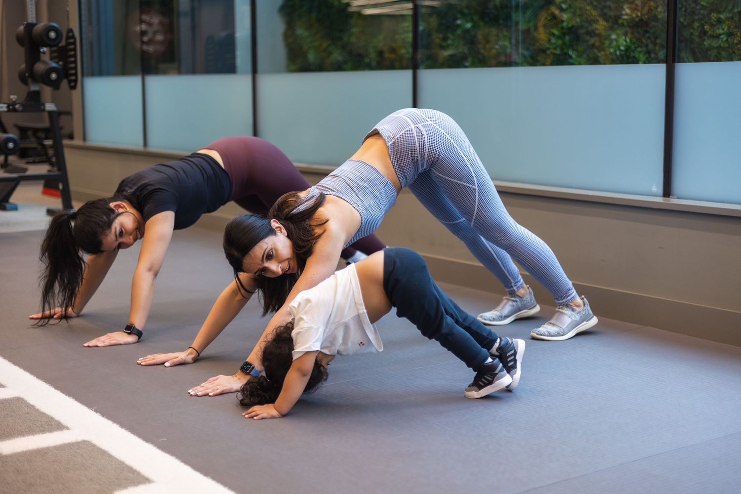 Visual storytelling of a personal trainer working with clients with children, and here we can see her training with the mum and child.