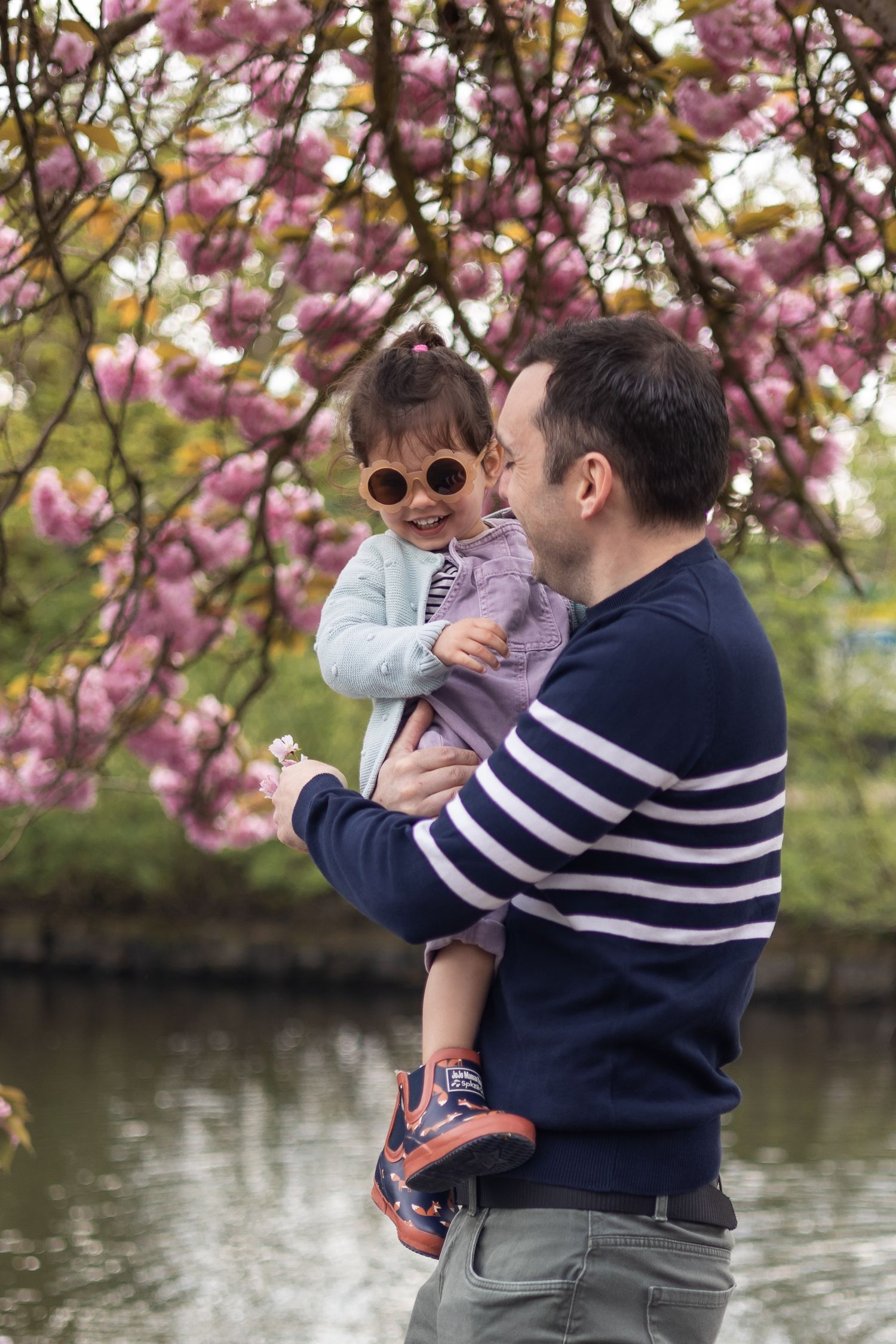 Father and daughter in front of cherry blossom at family shoot