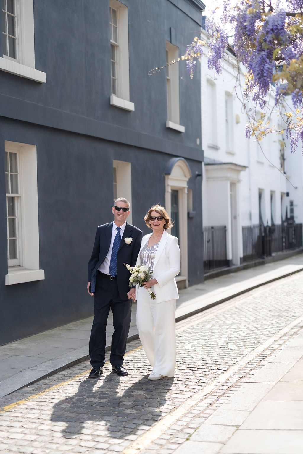 Beautiful light shining on couple as we walk through the streets of South Kensington during couple portraits after the intimate ceremony.