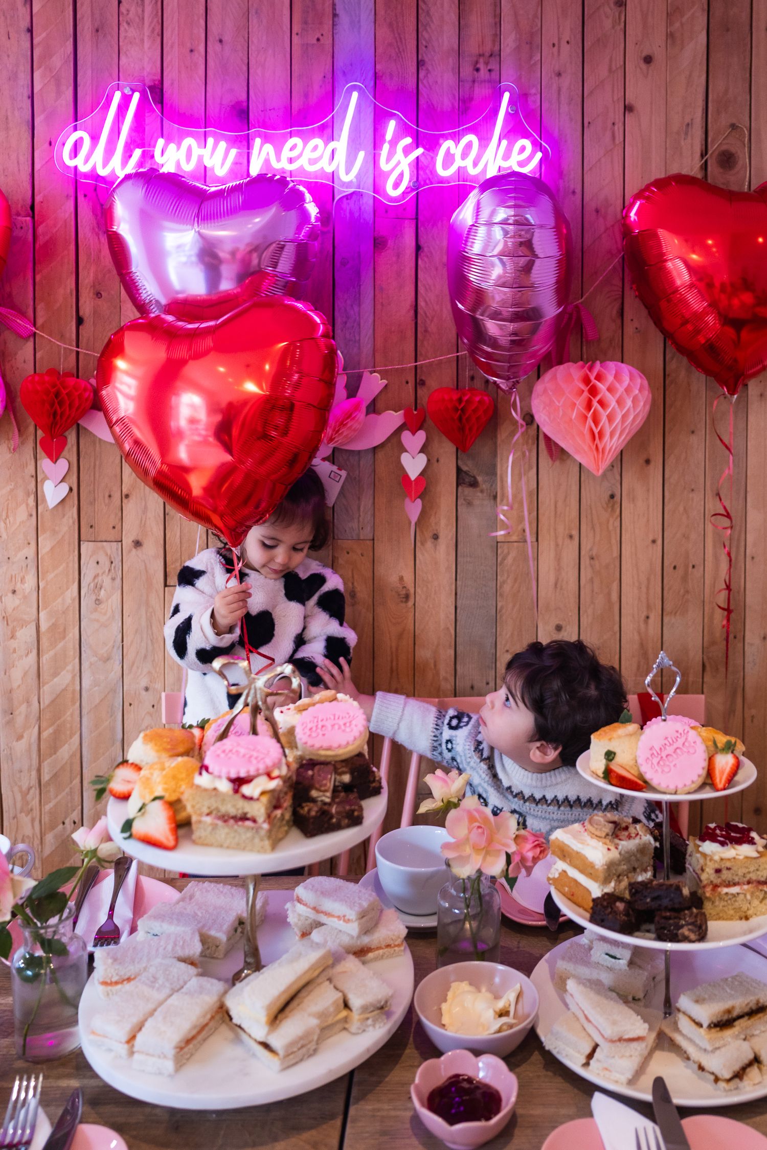 Inside local Barnet bakery, Marley's bakery. Two young children enjoying delicious treats.