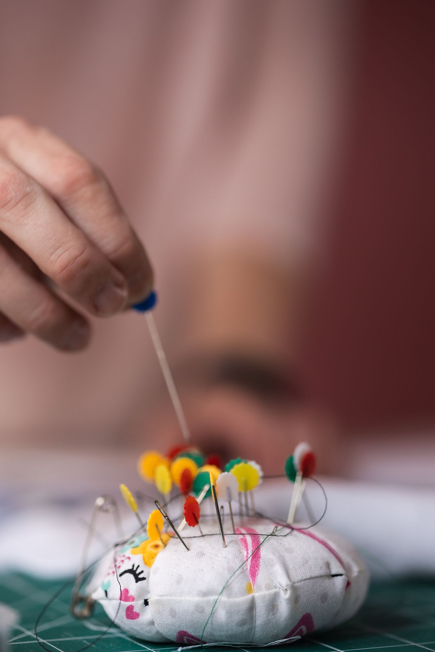 Close up detail image of small business owner, Ruth using the tools for her business of sewing. Taken in her studio in New Barnet.