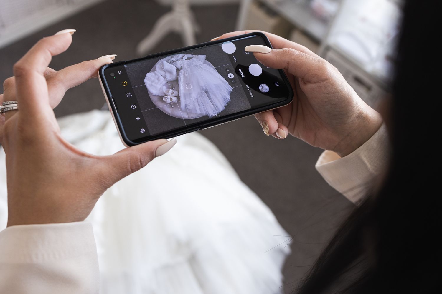 Behind the scenes of a local business owner taking photos on her phone of her product to post on social media.