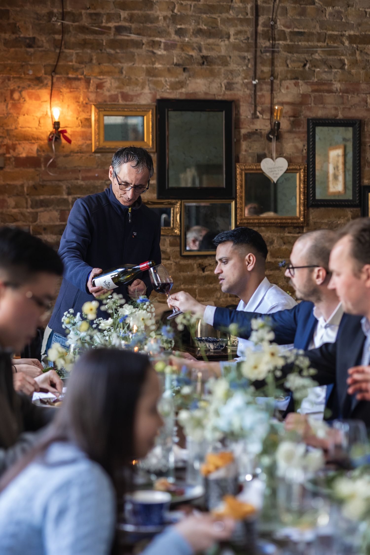 Guests enjoying food and wine at The Lady Ottoline in London