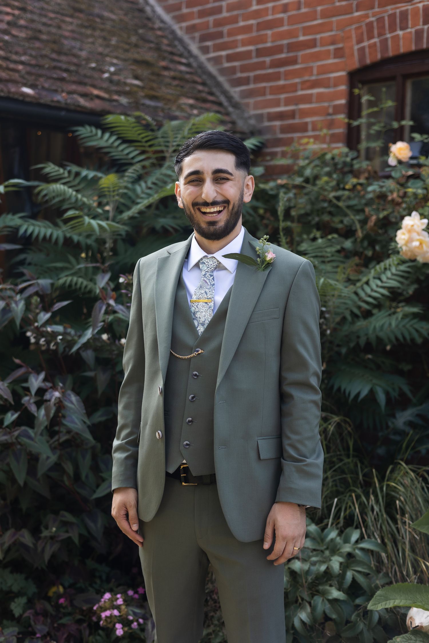 Groom portrait, looking at the camera, with a relaxed smile on his face.