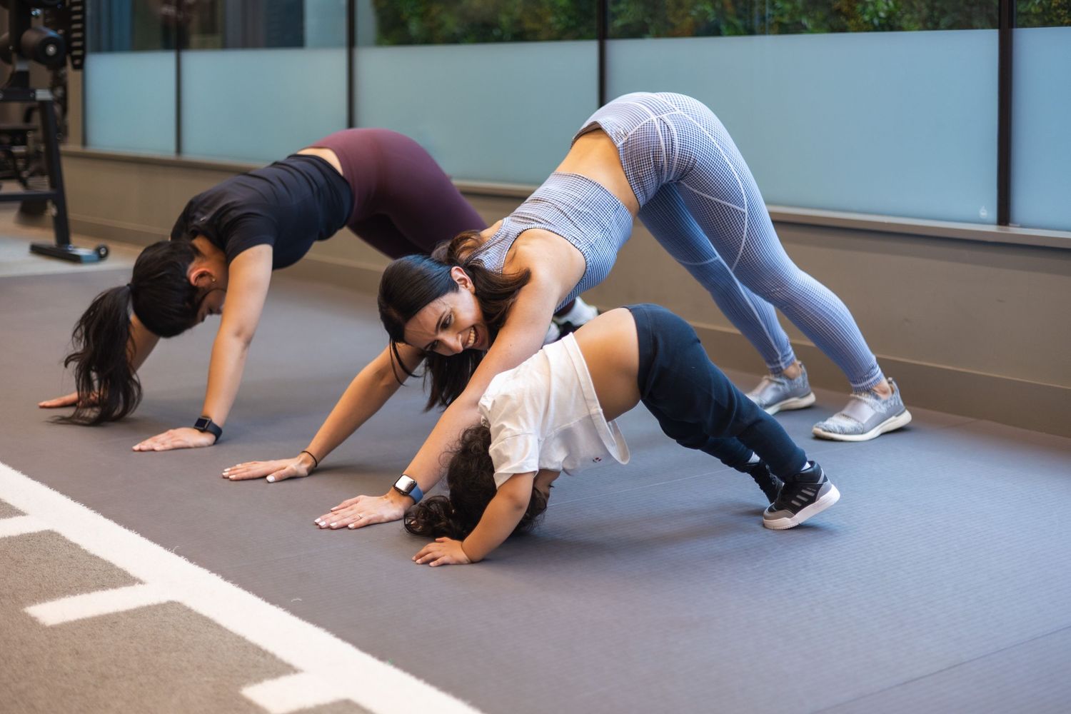 Visual storytelling of a personal trainer working with clients with children, and here we can see her training with the mum and child.