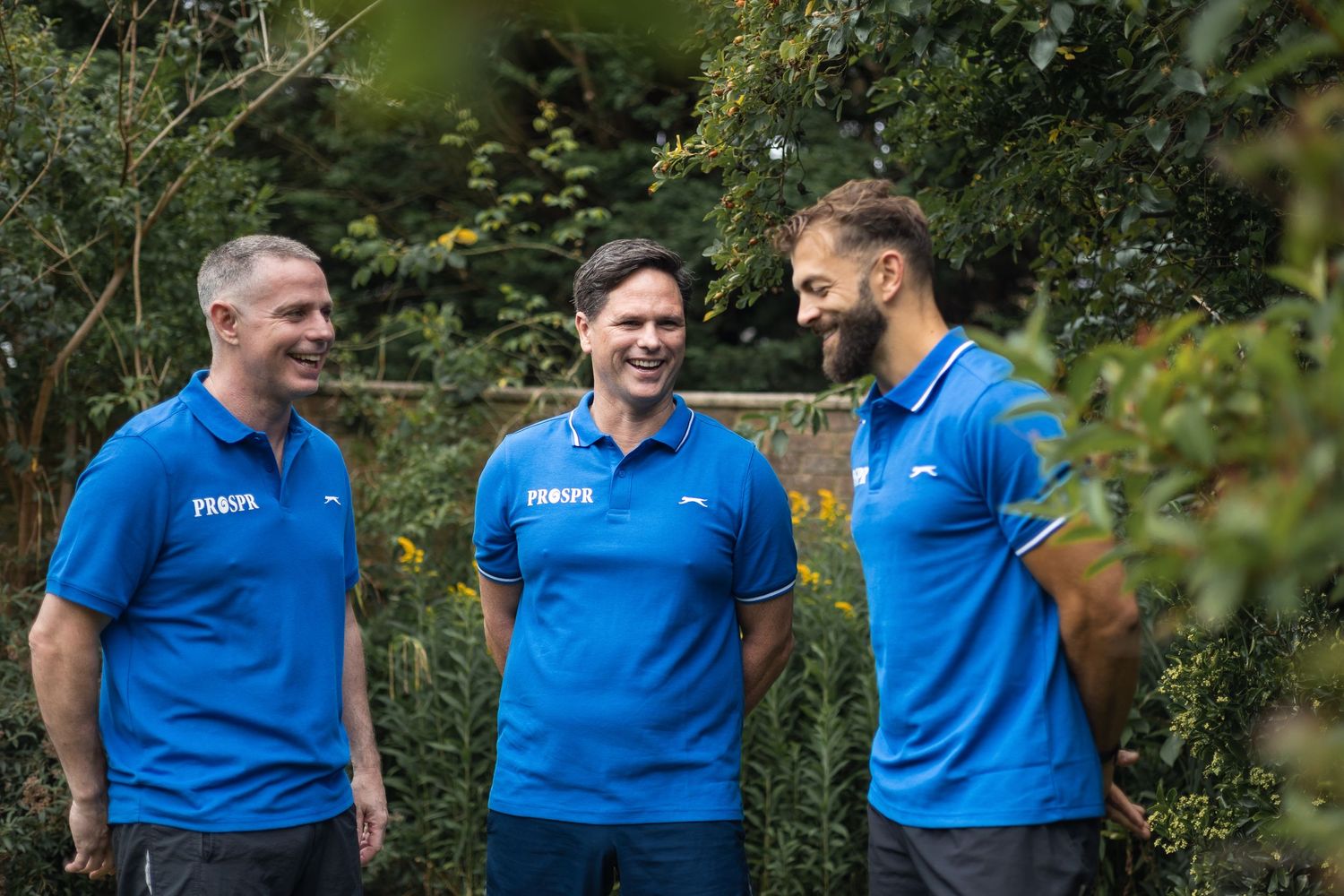 Relaxed photos of the team members interacting in the garden, full of smiles and connection.