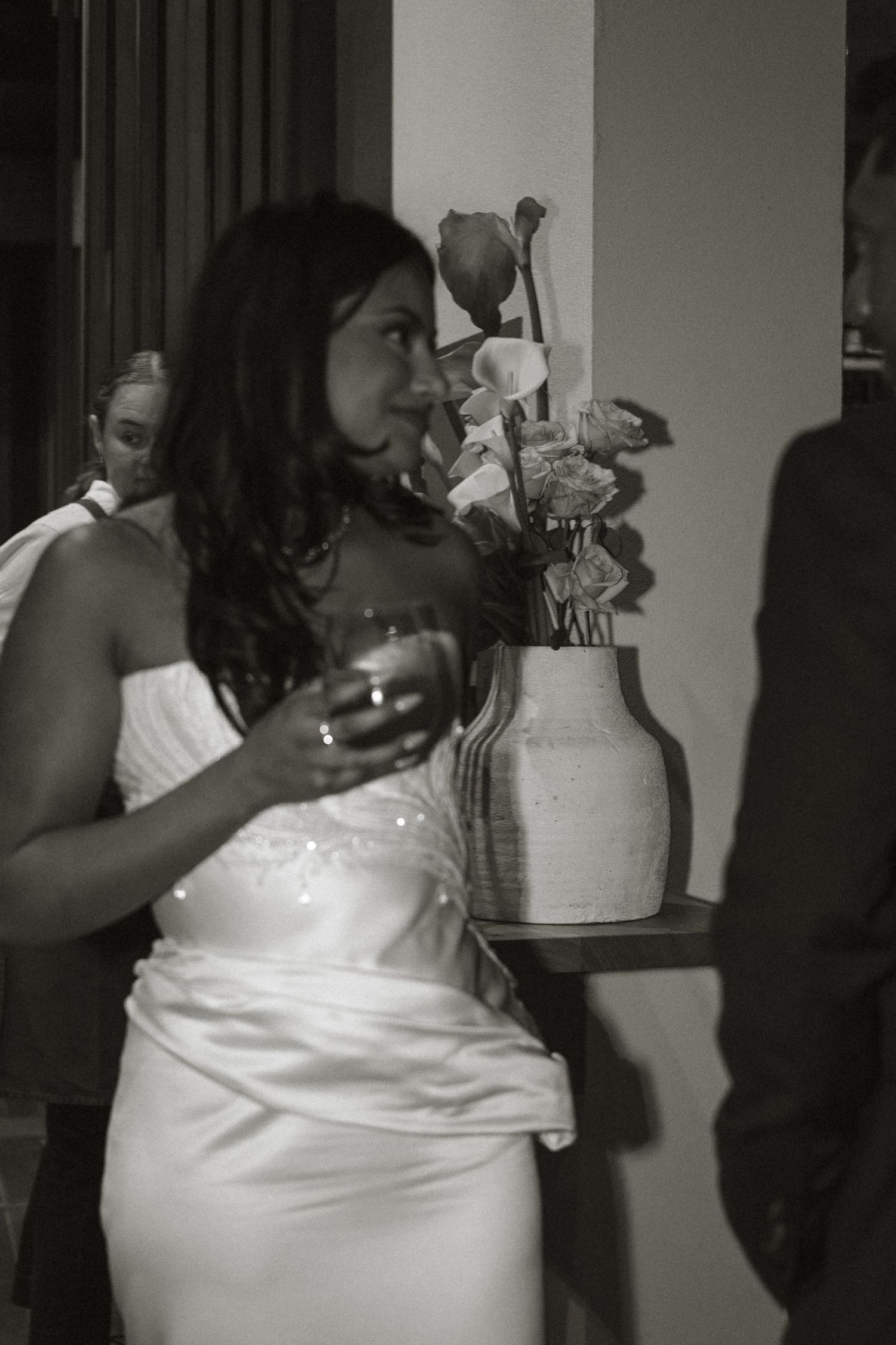 A sequence of photos shows someone in a white dress cutting and serving a wedding cake at a reception.