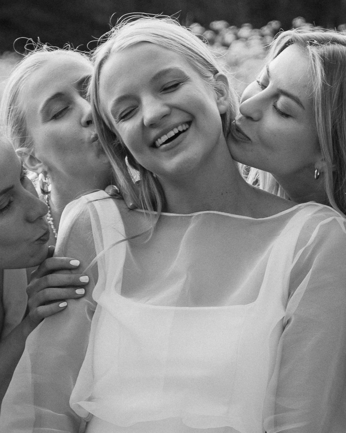A black and white sequence of photos showing emotional expressions of affection and joy.