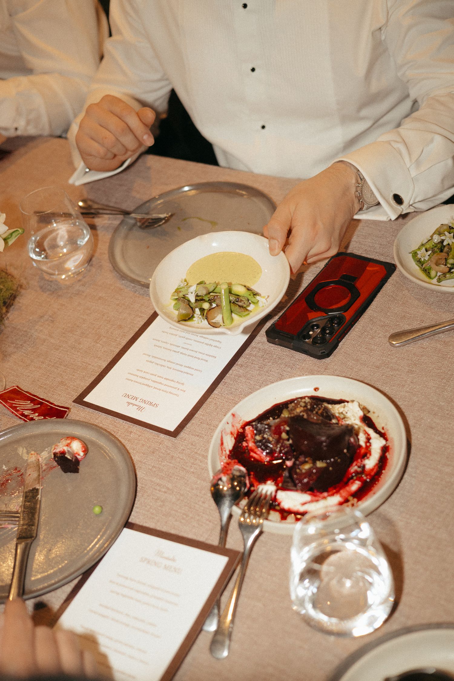A series of dining table photos showing empty plates, menus, and table settings at an upscale restaurant.