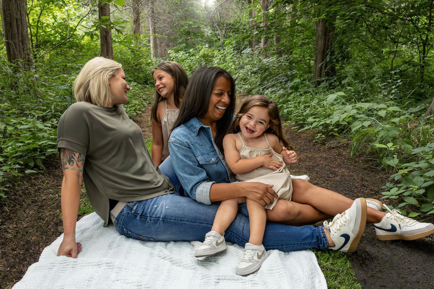 A carousel of candid lifestyle photos showing friends laughing and enjoying time together on a forest path.