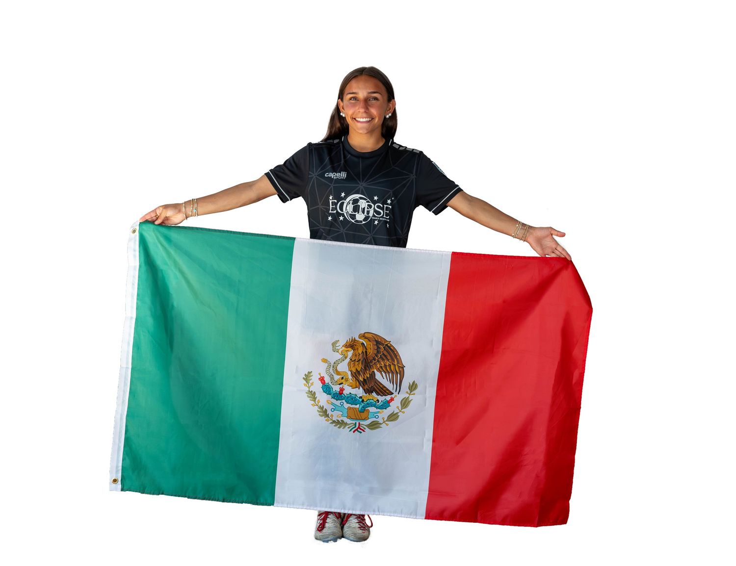 Someone holds up and displays the Mexican flag with its distinctive tricolor design and eagle emblem in the center.