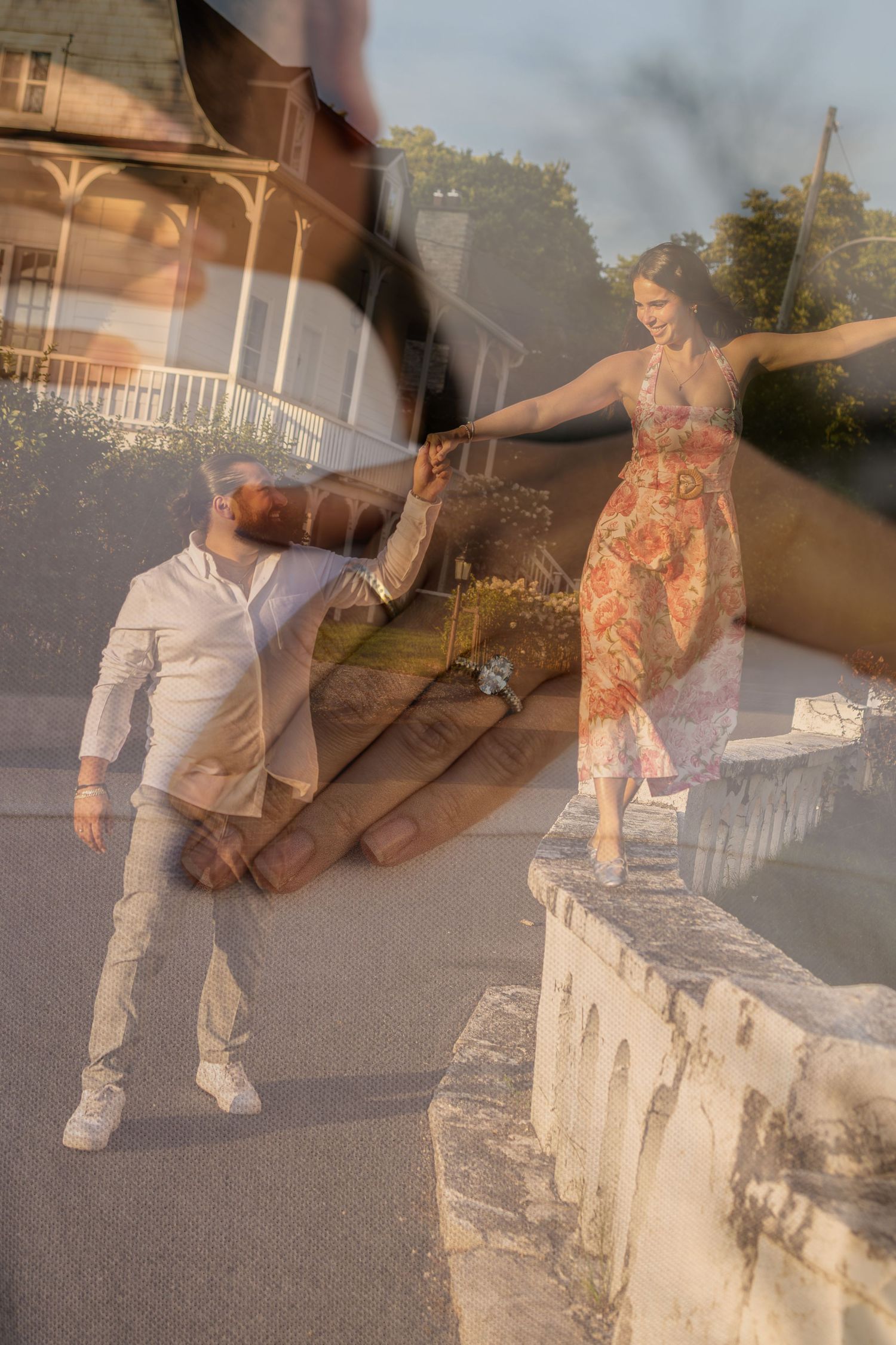 Double exposure photo of a couple holding hands, man in white shirt and woman in floral dress, with a house backdrop.