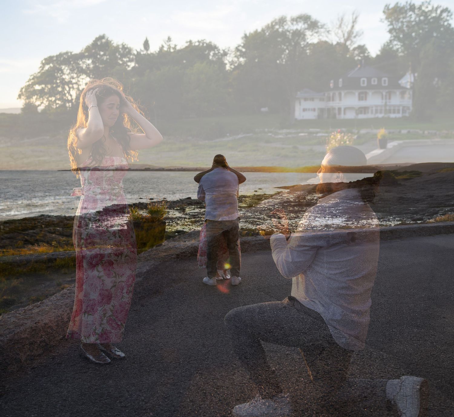 Double exposure photo of people on rocky New England coastline with historic white house and trees in background.