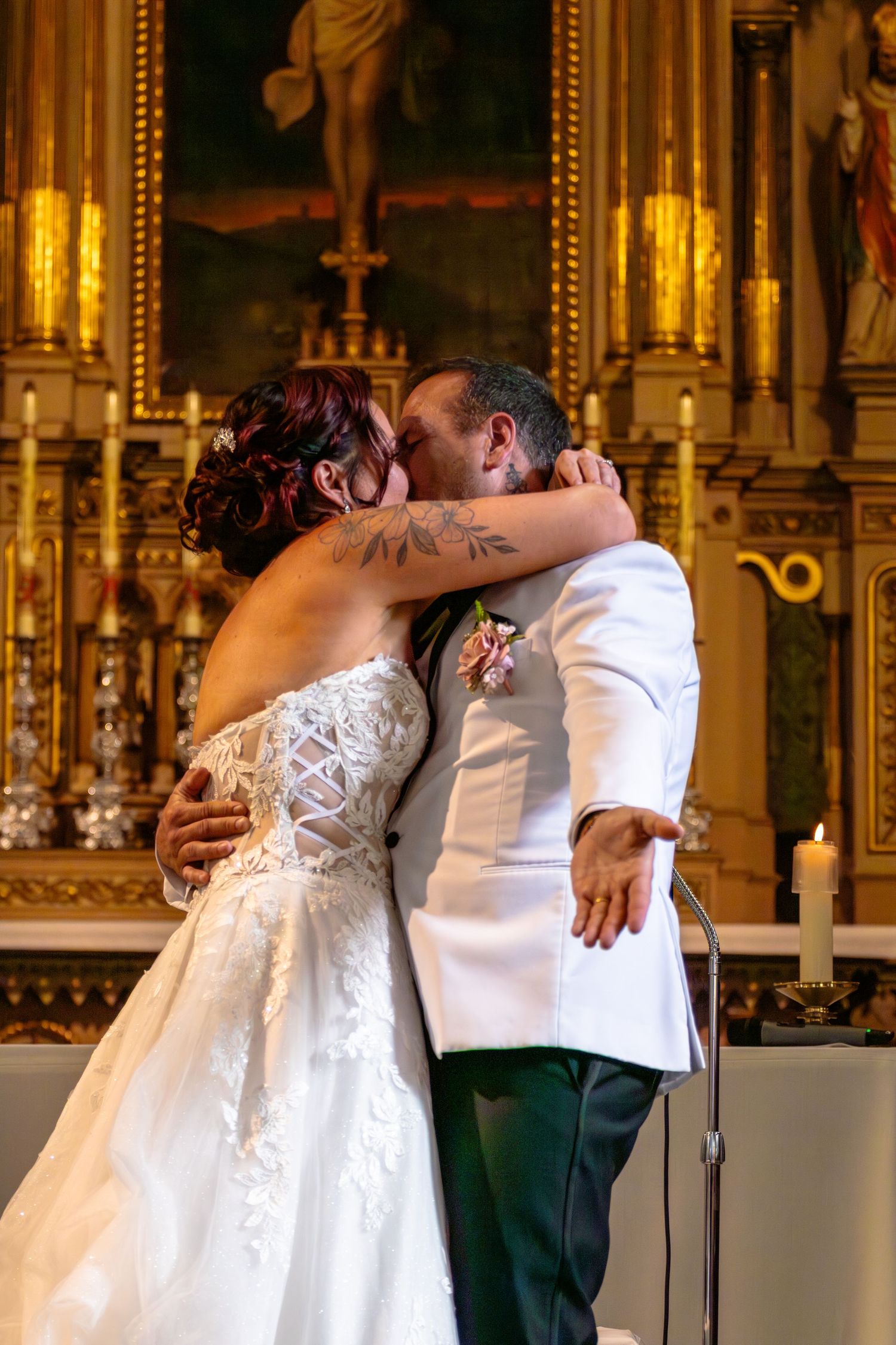 Bride and groom share their first kiss at the altar during a church wedding ceremony.