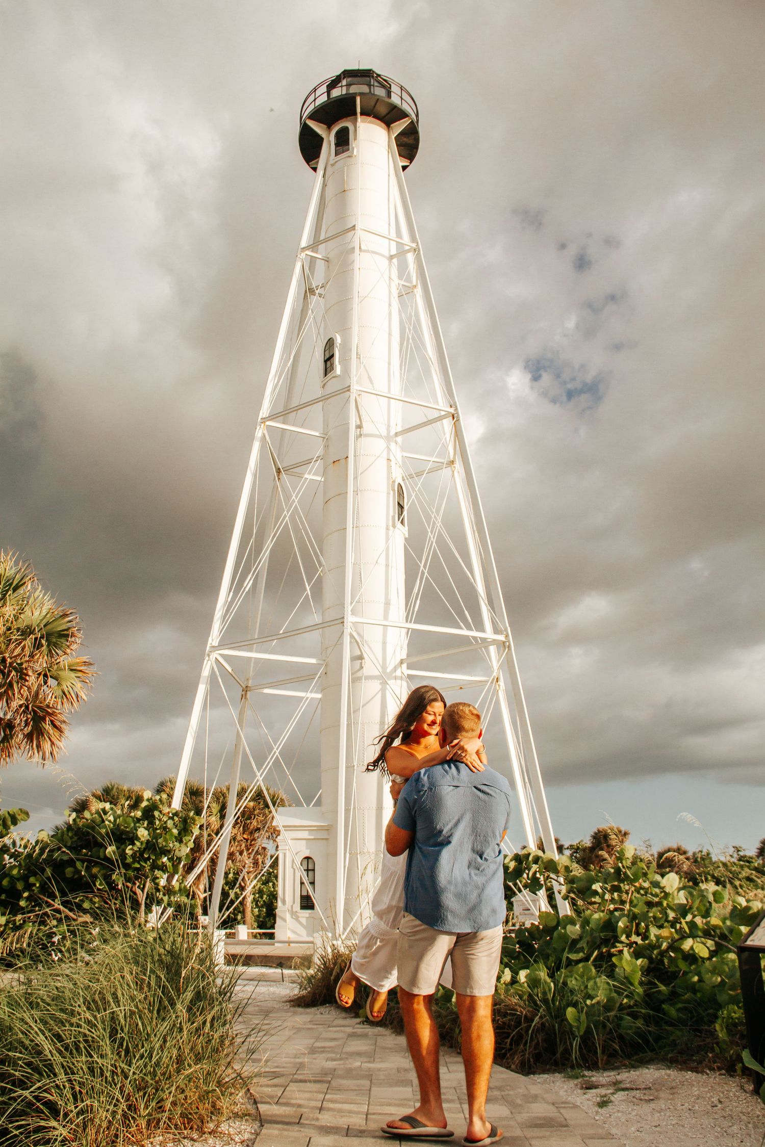 A series of lighthouse photos showing people admiring scenic coastal views under dramatic cloudy skies.