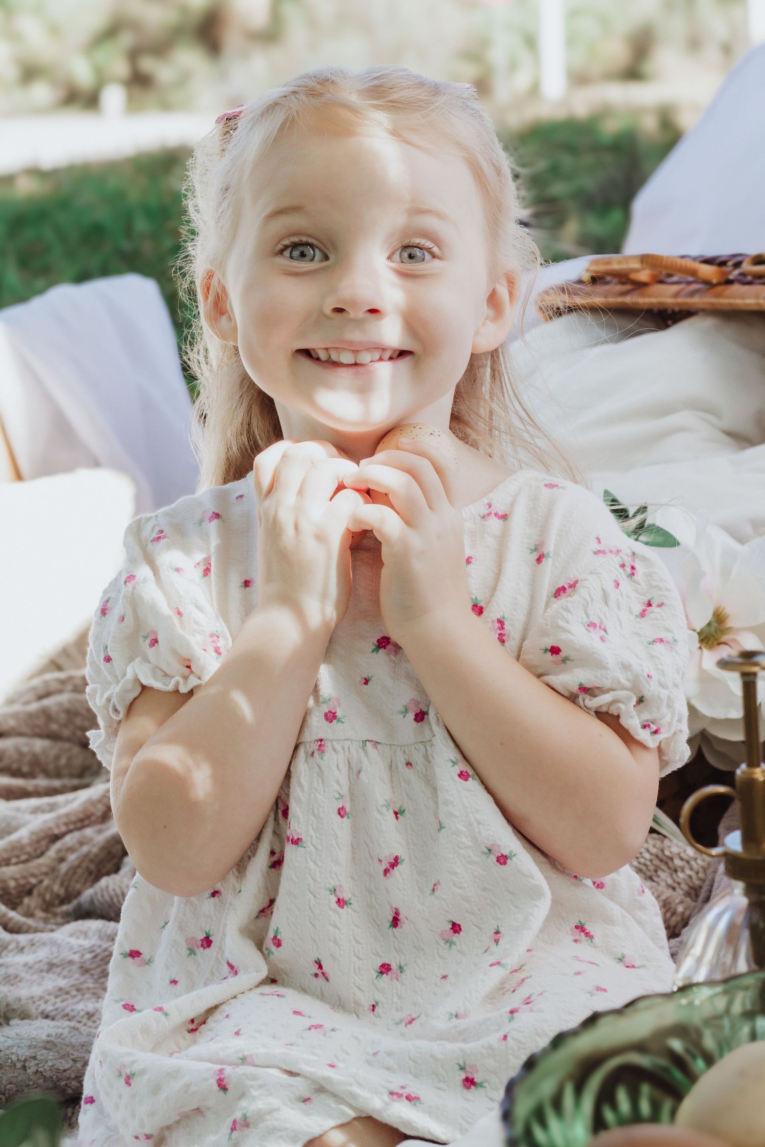 Whimsical Easter portrait with floral dress and natural decor elements.