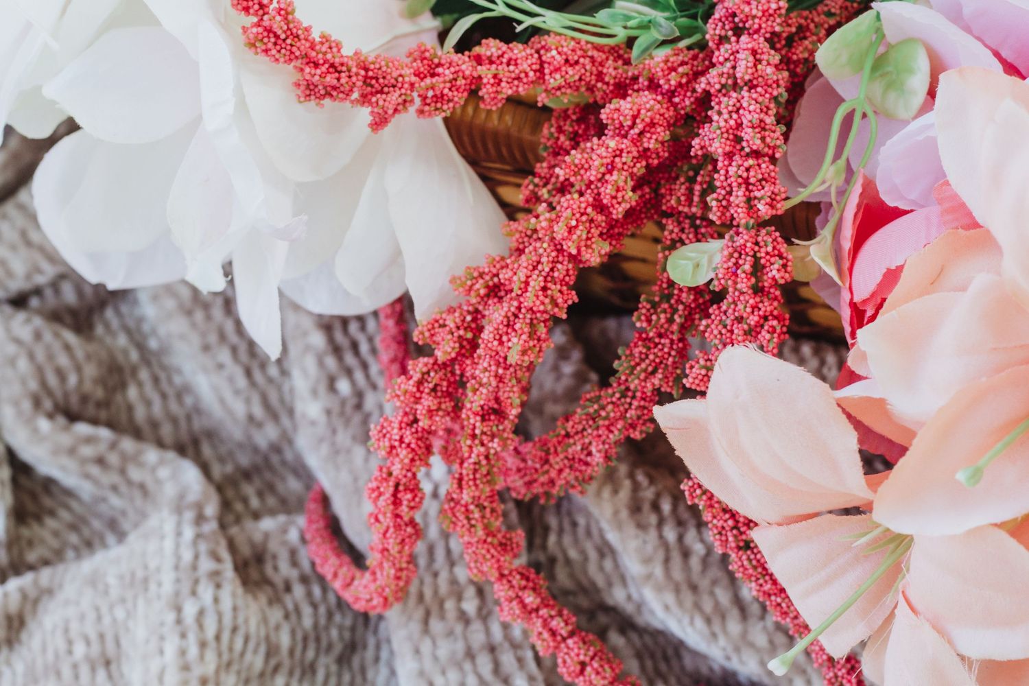 Pink floral arrangement with vibrant coral amaranth flowers and soft rose petals.