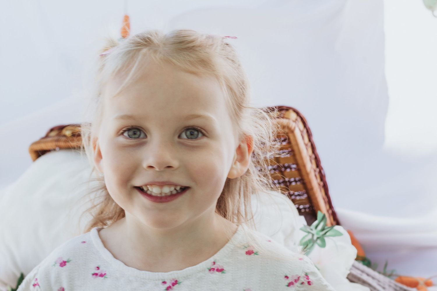 Bright and airy portrait with soft natural lighting and white backdrop.