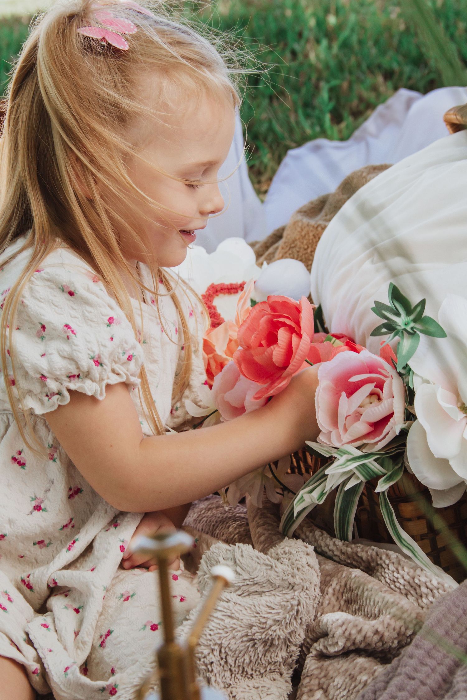 Springtime scene with delicate pink flowers and floral patterned fabric.