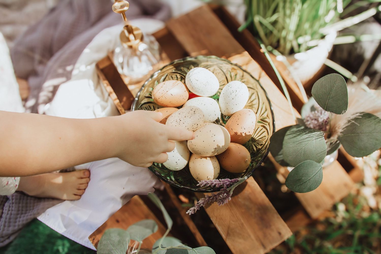 Rustic decorative display of wooden elements, spring greenery, and Easter eggs.