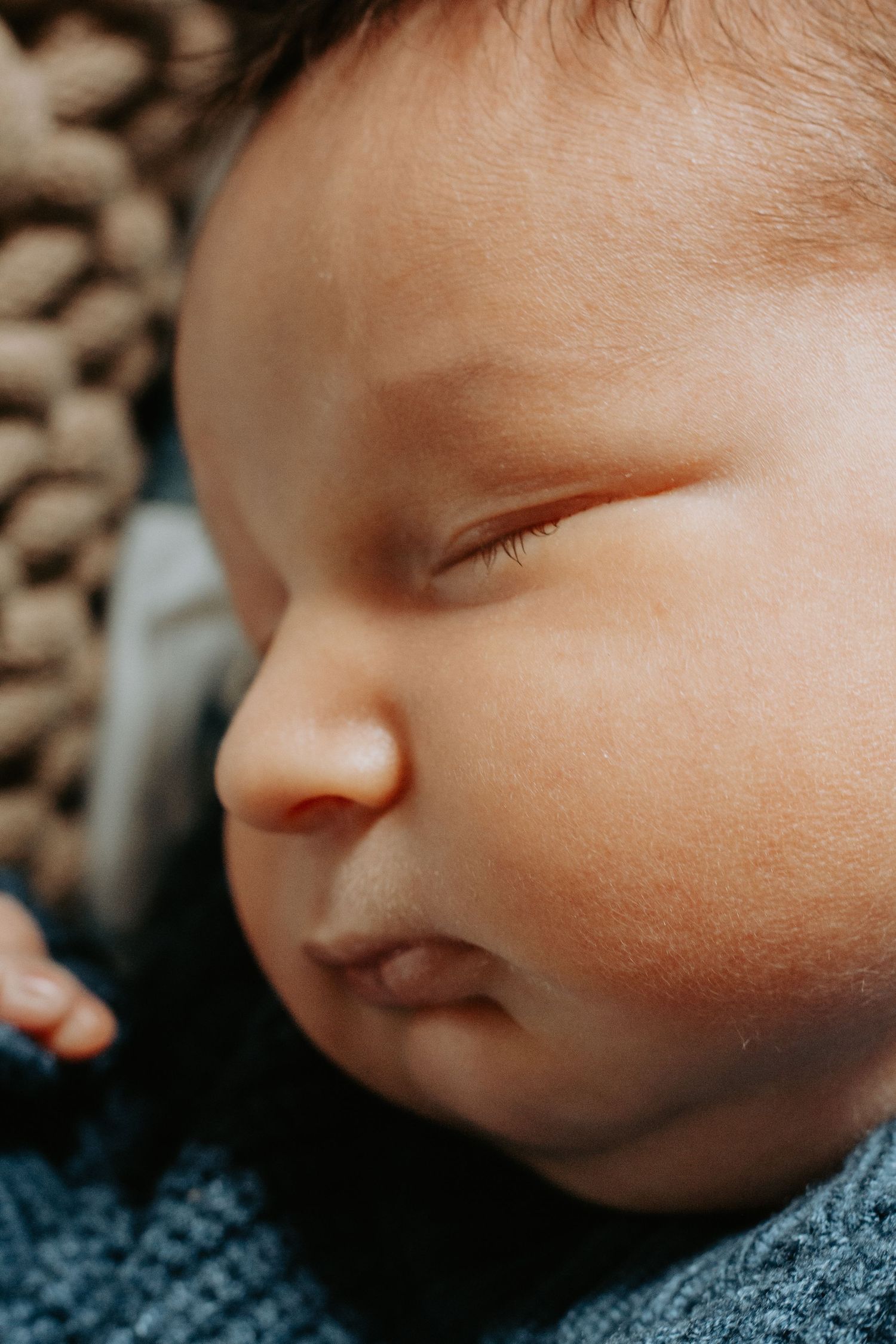Close-up portrait of a peaceful sleeping newborn baby with soft skin and delicate features.