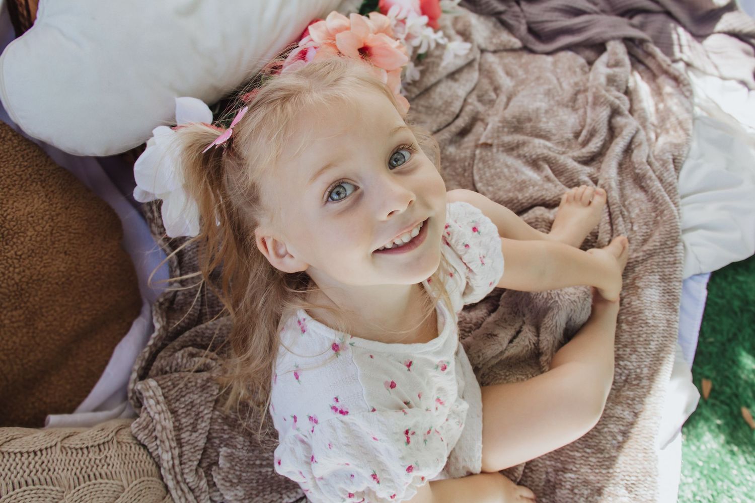 Artistic overhead shots of baby lying on soft fabric with natural lighting.